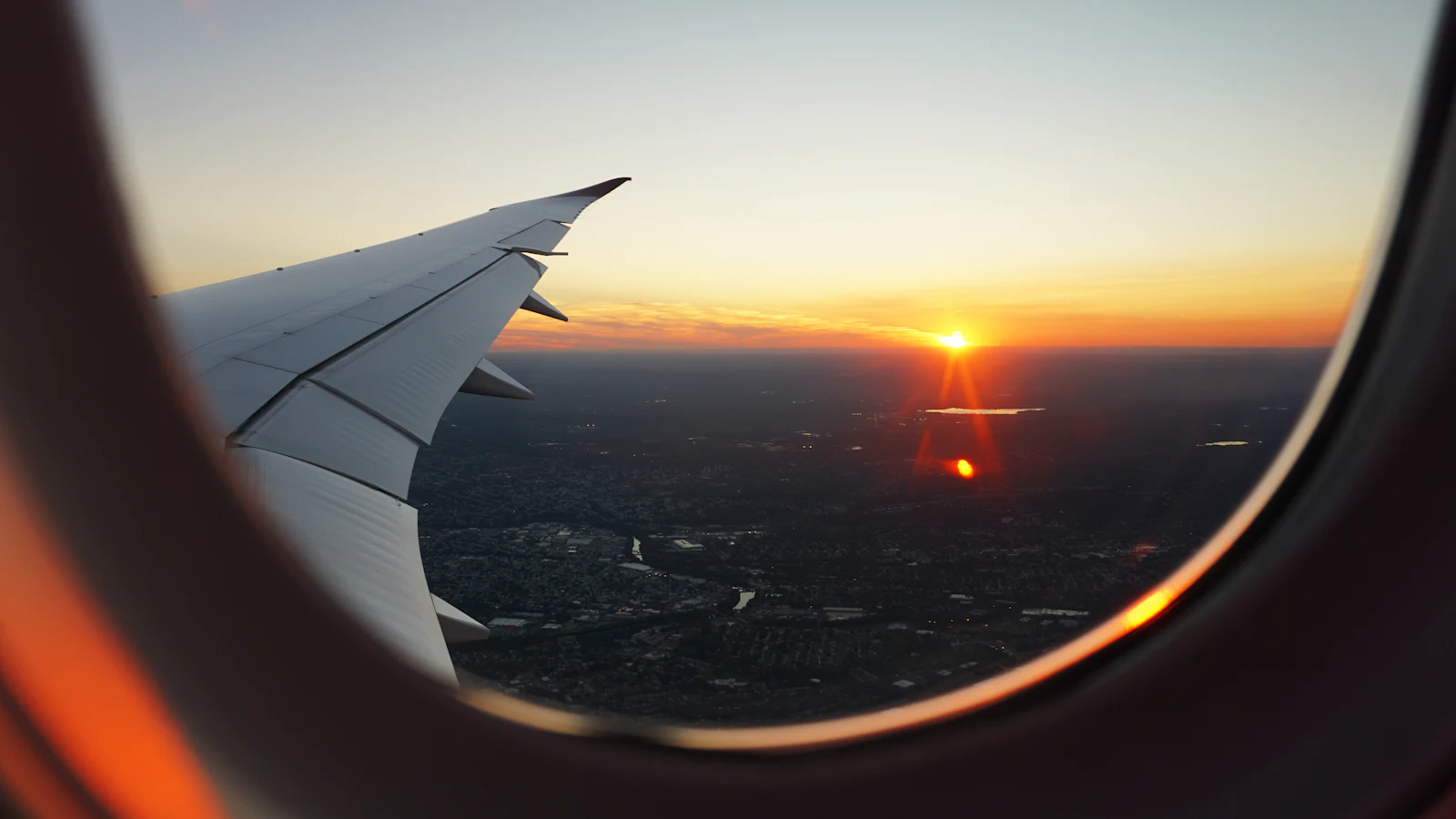 Vista do pôr do sol pela janela de um avião
